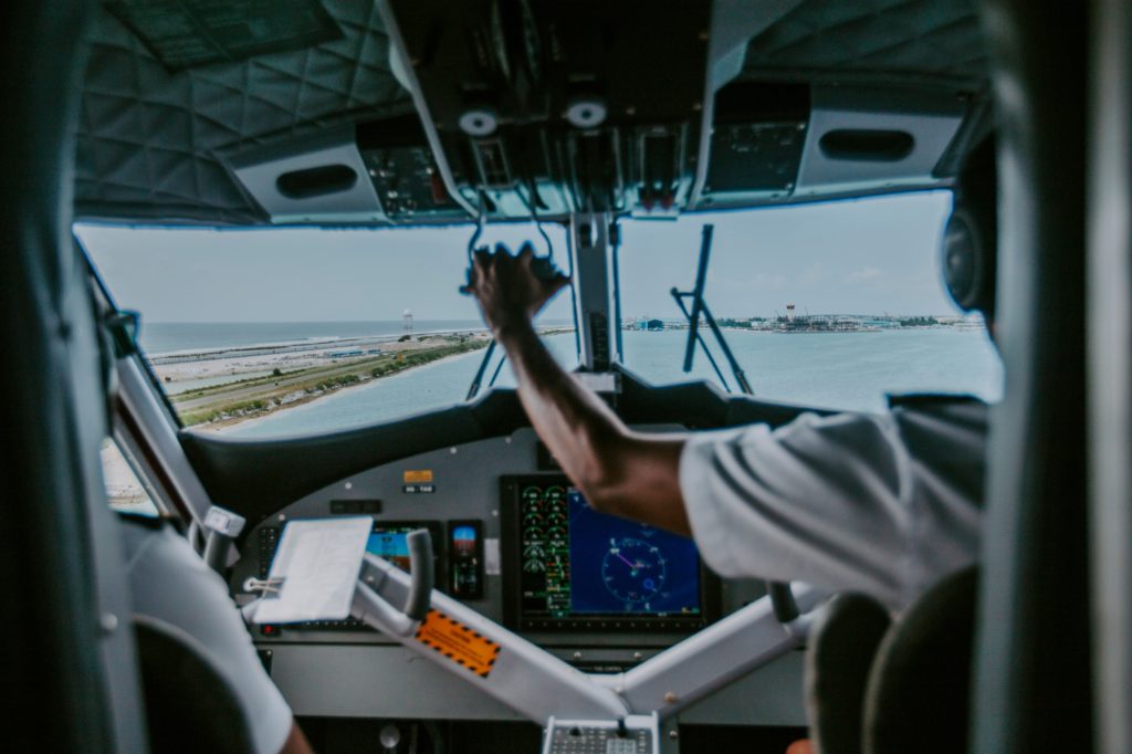 Sea plane passenger looking at sea plane pilot and co pilot drive the plane